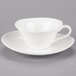 A close-up of a 10 Strawberry Street white bone china cappuccino cup on a saucer.