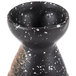 A black and white speckled stoneware sake bottle.