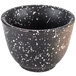 A white speckled stoneware sake cup with a black and white speckled design.