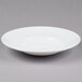 A 10 Strawberry Street white bone china bowl on a gray surface.