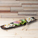 A rectangular 10 Strawberry Street Nagoya stoneware platter with sushi rolls on a wood surface.