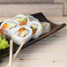 10 Strawberry Street rectangular coupe stoneware platter with sushi on a wood surface.