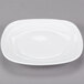 A 10 Strawberry Street Bright White Porcelain side plate with wavy edges.