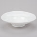 A 10 Strawberry Street bright white porcelain pasta bowl with a small rim on a gray surface.