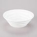 A 10 Strawberry Street bright white porcelain bowl with wavy lines on a white surface.