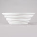 A white porcelain bowl with wavy lines.