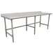 An Advance Tabco stainless steel work table with an open base and white surface.
