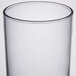 A close up of a clear Arcoroc Collins glass with a black rim.