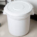 A white plastic Continental trash can lid on a white plastic trash can.