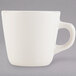 A Tuxton eggshell white china cup with a handle.