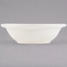 A white Tuxton China bowl with a white rim.