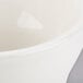 A white Tuxton china bouillon cup with a white rim.
