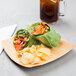 A plate of food with a drink on the side on a TreeVive by EcoChoice palm leaf plate.