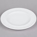 An Arcoroc white porcelain brunch plate with a rim.