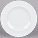 An Arcoroc white brunch plate with a white rim.