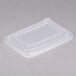 A clear plastic Genpak rectangular lid on a white surface.