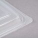 A close-up of a Genpak clear rectangular plastic container with a lid.