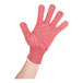 A hand wearing a red San Jamar cut resistant glove.