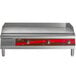 An Avantco electric countertop griddle with red knobs on a counter.