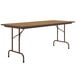 A brown rectangular Correll folding table with metal legs.