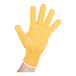 A hand wearing a yellow San Jamar cut resistant glove with five fingers.