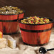 A GET Melamine Gourmet Barrel filled with olives and cheese on a table in a salad bar.