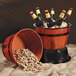 A GET melamine barrel filled with beer bottles and peanuts.