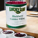 A can of Lucky Leaf blackberry cobbler filling on a table.