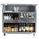 A Cambro granite and slate gray portable bar cart with bottles of alcohol.