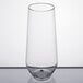 A clear plastic stemless flute on a white surface.