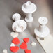 A white plastic Ateco 3-piece plunger cutter set with heart shapes.