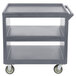 A grey plastic Cambro utility cart with three shelves and wheels.