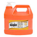 A plastic jug of GOJO Natural Orange liquid hand soap with a white pump.