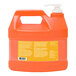 A plastic jug of GOJO Natural Orange hand cleaner with a white lid.