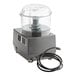 A grey Robot Coupe commercial food processor with a cord.