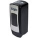 A close-up of a black and silver GOJO ADX-7 soap dispenser.