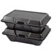 A stack of Genpak black foam hinged lid containers.