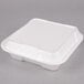 A white Genpak foam takeout container with a hinged lid.
