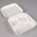 A white styrofoam Genpak hinged lid container with three compartments.
