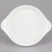 A CAC white stoneware round plate with handles.