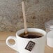 A cup of tea with a Royal Paper Eco-Friendly Wood Coffee Stirrer in it.