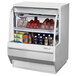 A white Turbo Air refrigerated deli case with food inside.