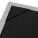 A Menu Solutions brushed aluminum menu board with picture corners on a black board.