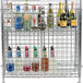 A Regency chrome wire security cage filled with bottles of brown liquid.