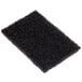 A black sponge for griddle cleaning on a white background.