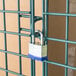 A padlock on a Regency green metal wire security cage.