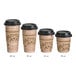 A group of Choice kraft paper coffee cups with black lids and sleeves.