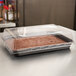 A Solut quarter size sheet pan with a cake in a plastic container.