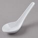 A white melamine soup spoon with a white handle on a gray surface.