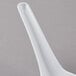 A close-up of a white GET Melamine soup spoon with a long handle.